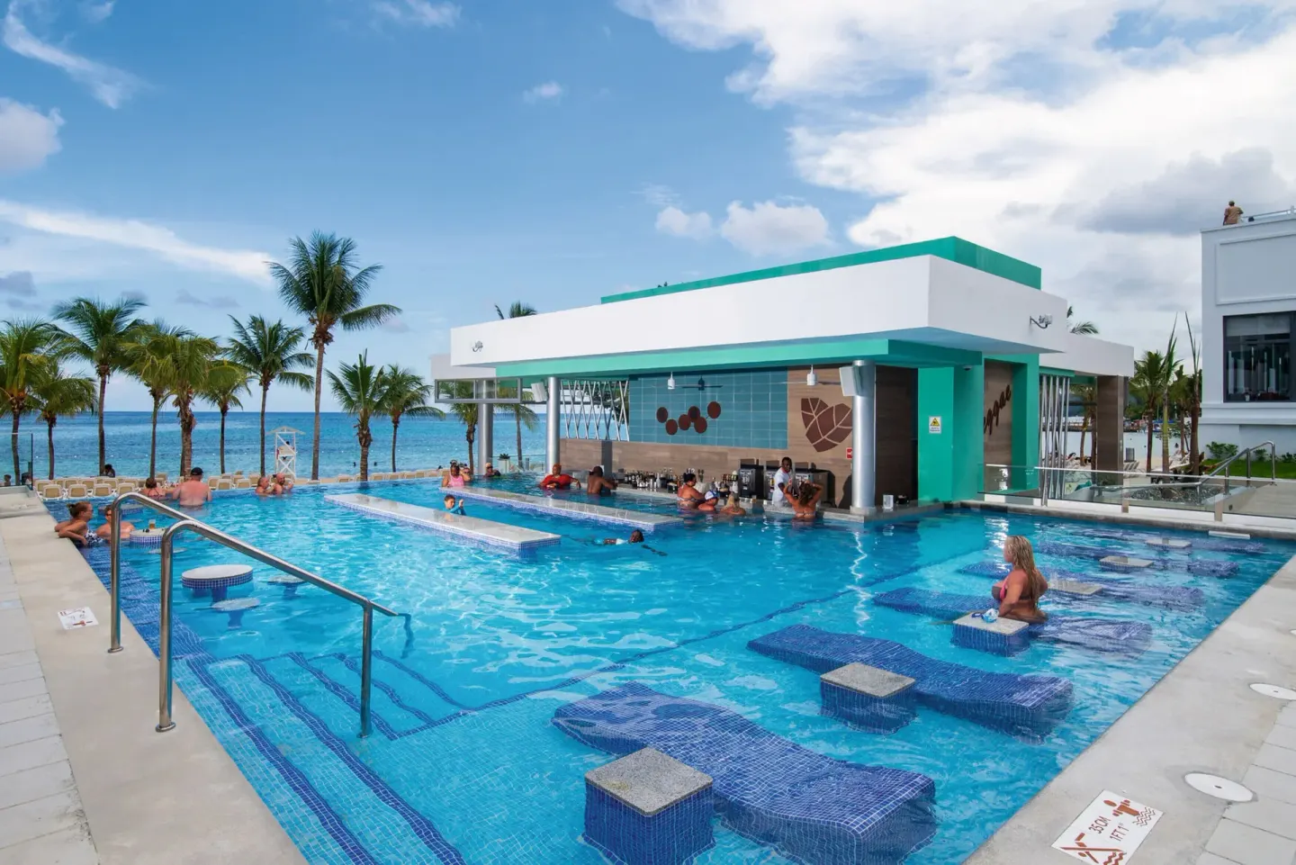 Guests in the pool around the swim-up bar at Hotel Riu Ocho Rios.