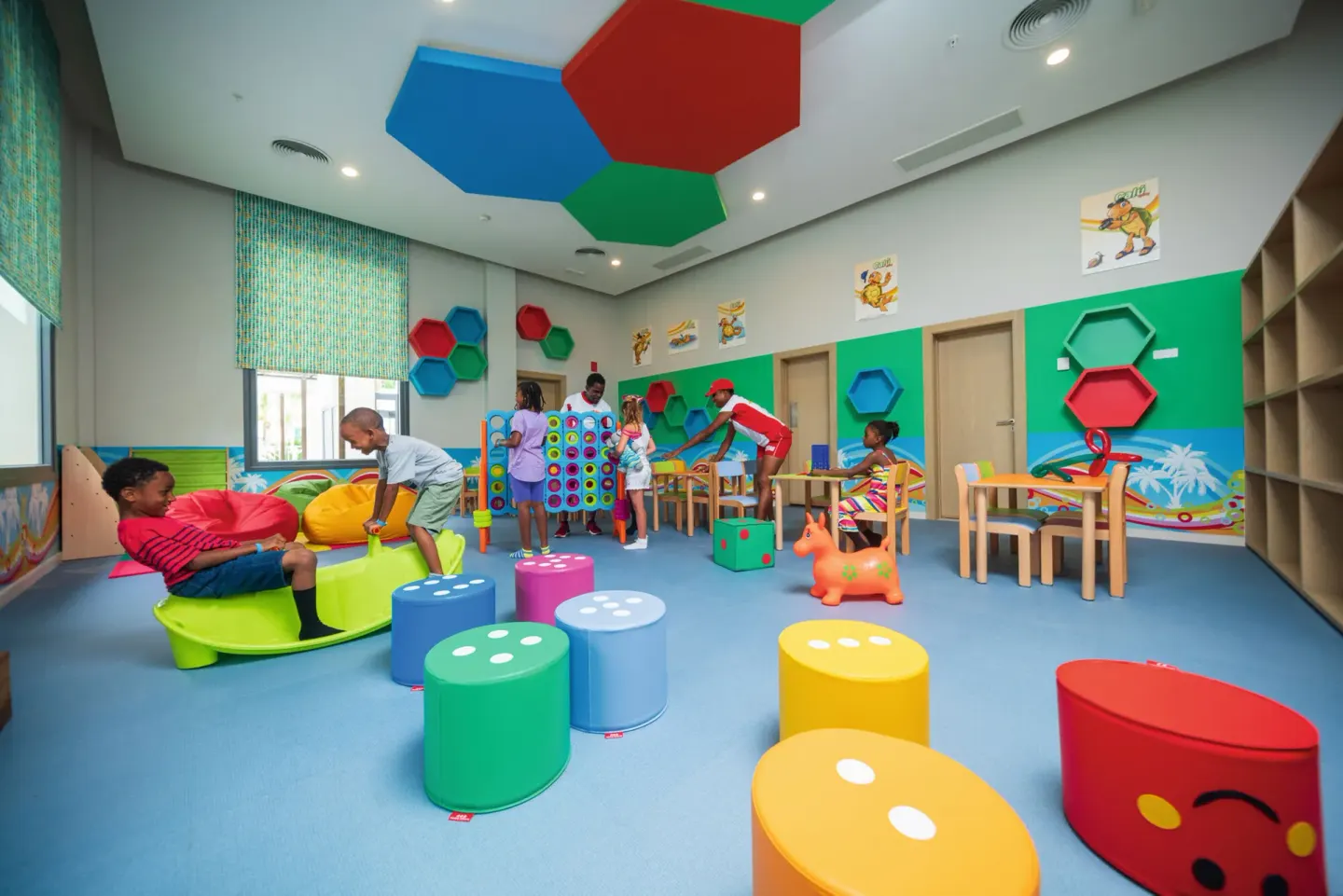 Children's activity room with colorful stools at Hotel Riu Ocho Rios.