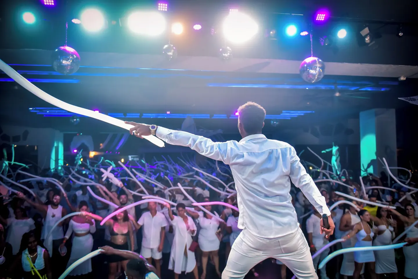 An entertainer leads a crowd with long balloons at Hotel Riu Ocho Rios.