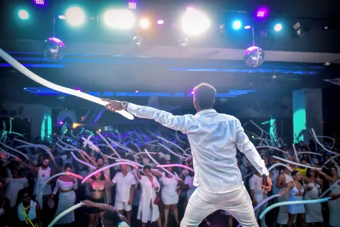 An entertainer leads a crowd with long balloons at Hotel Riu Ocho Rios.