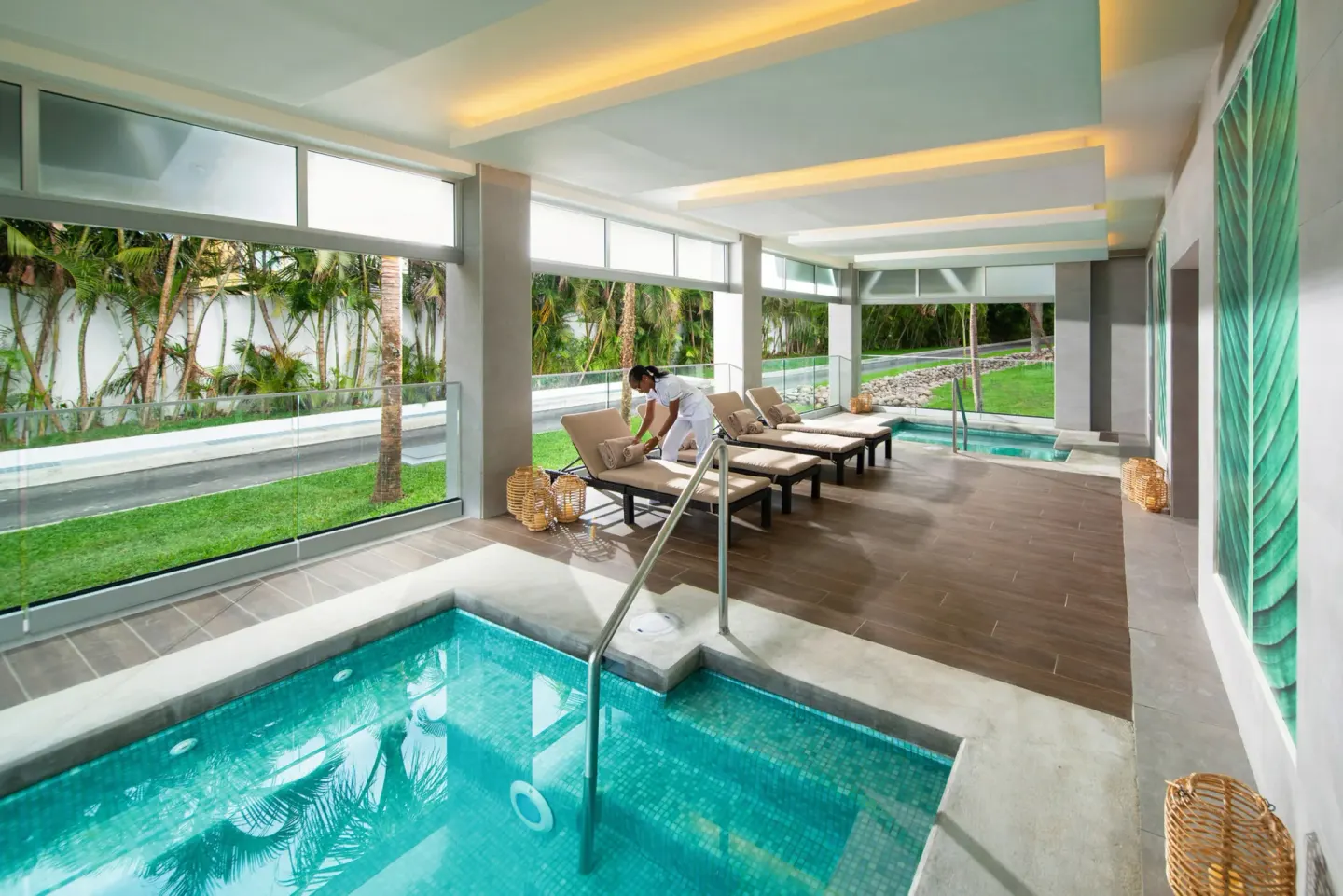 Indoor spa pool with loungers and garden views at Hotel Riu Ocho Rios.