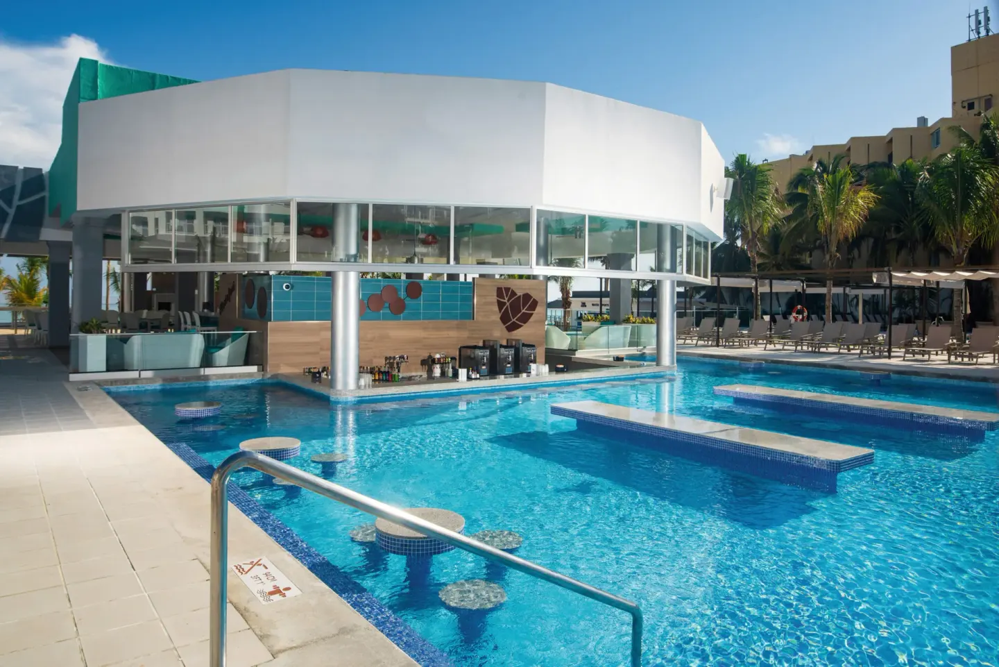 Swim-up pool bar and submerged seating at Hotel Riu Ocho Rios.