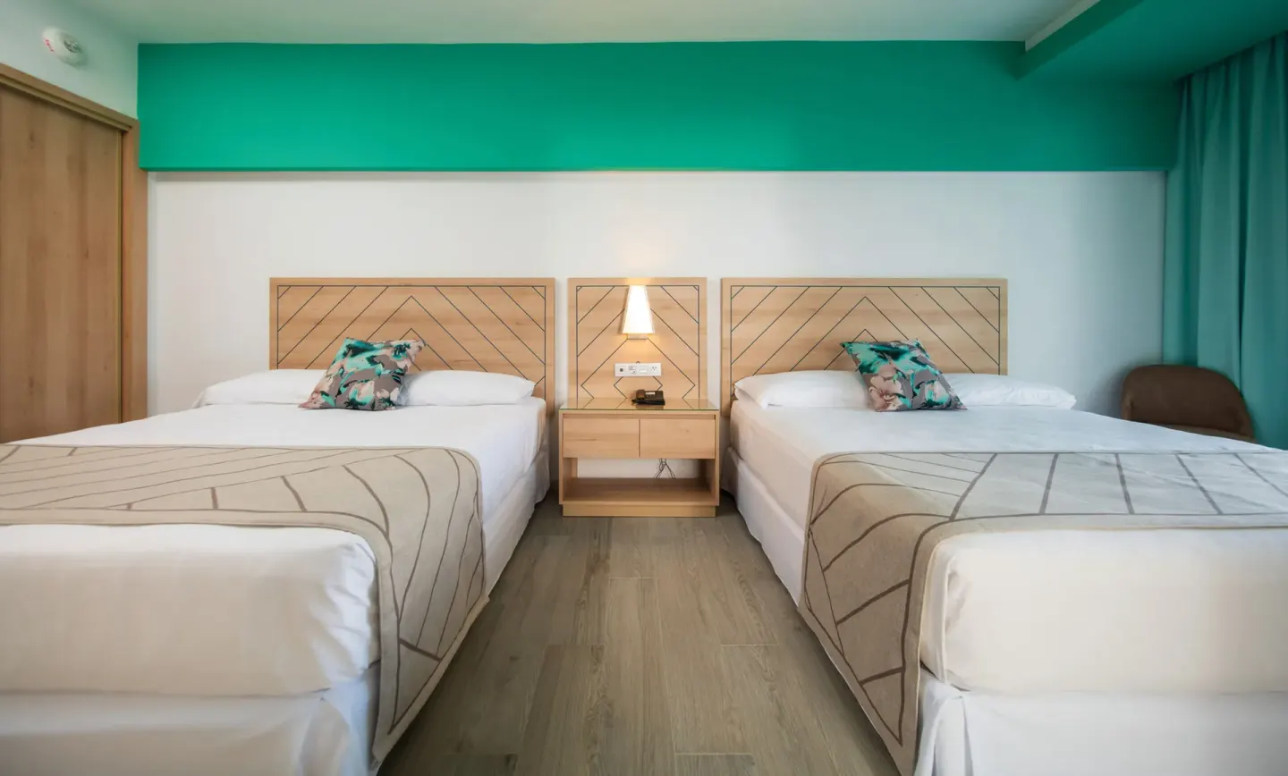 Two double beds in a Family Room bedroom at Hotel Riu Ocho Rios.