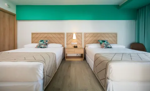 Two double beds in a Family Room bedroom at Hotel Riu Ocho Rios.