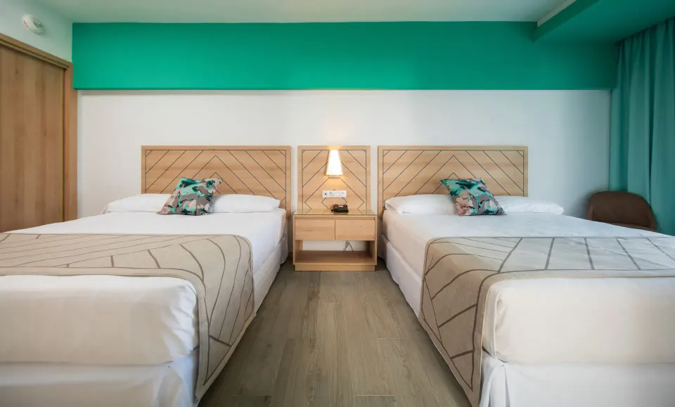 Two double beds in a Family Room bedroom at Hotel Riu Ocho Rios.