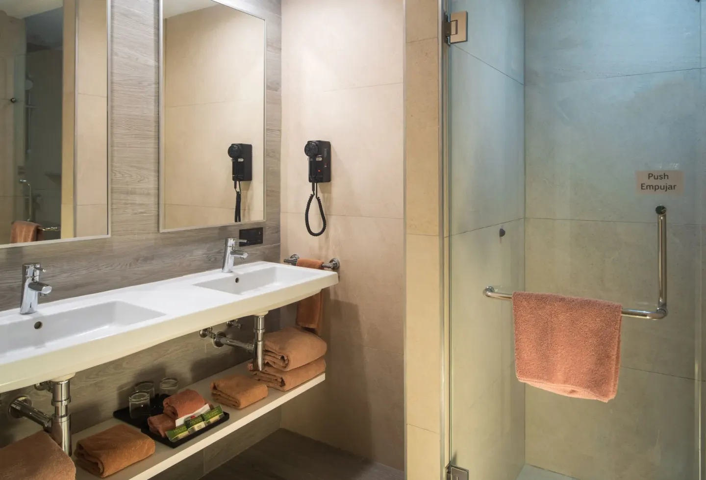Family Room bathroom with double sink vanity and glass shower at Hotel Riu Ocho Rios.