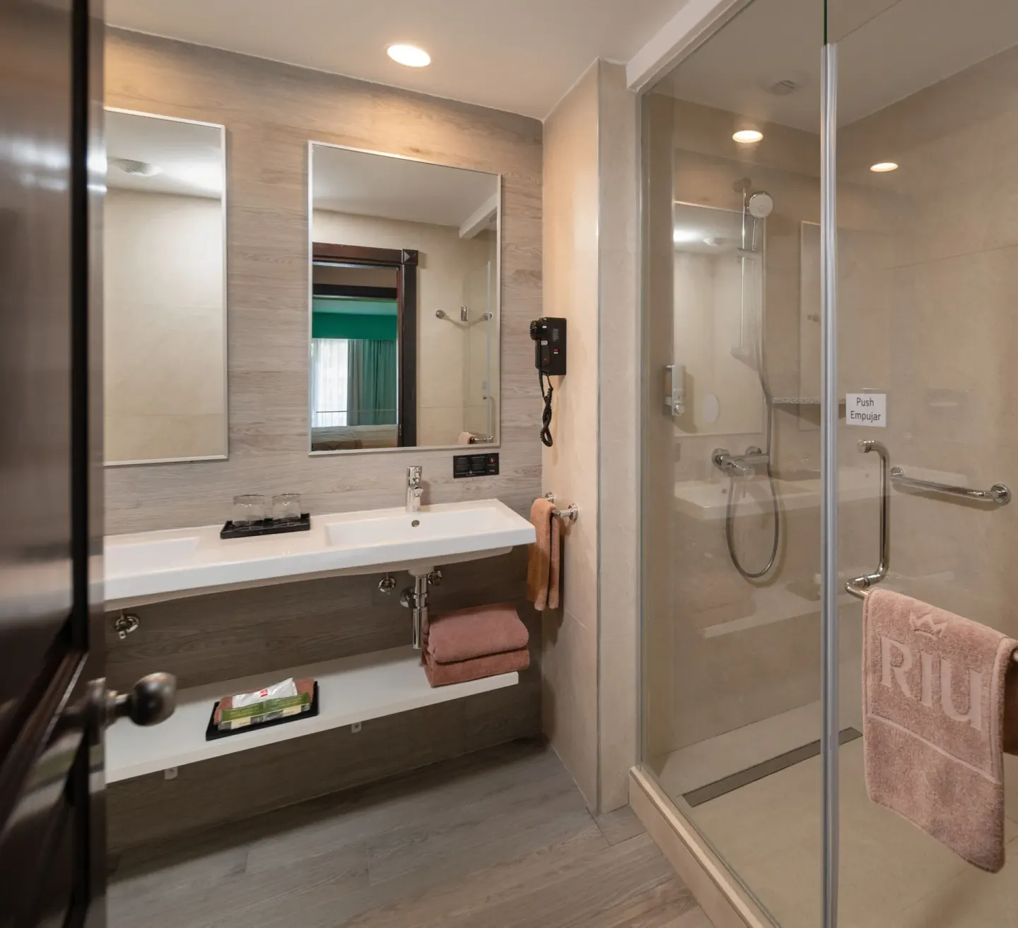 Junior Suite Garden View bathroom with vanity and glass shower at Hotel Riu Ocho Rios.