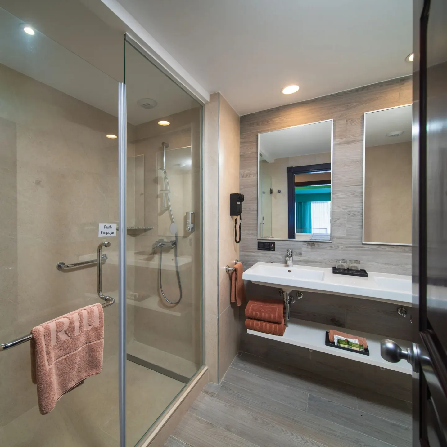Junior Suite Ocean View bathroom with glass shower at Hotel Riu Ocho Rios.