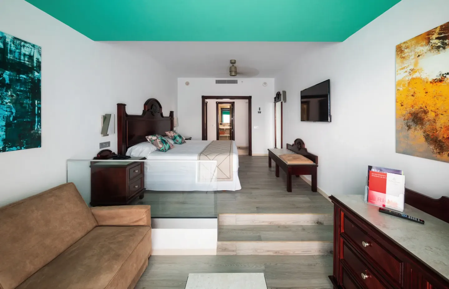 Junior Suite Ocean View sitting area and raised bedroom at Hotel Riu Ocho Rios.