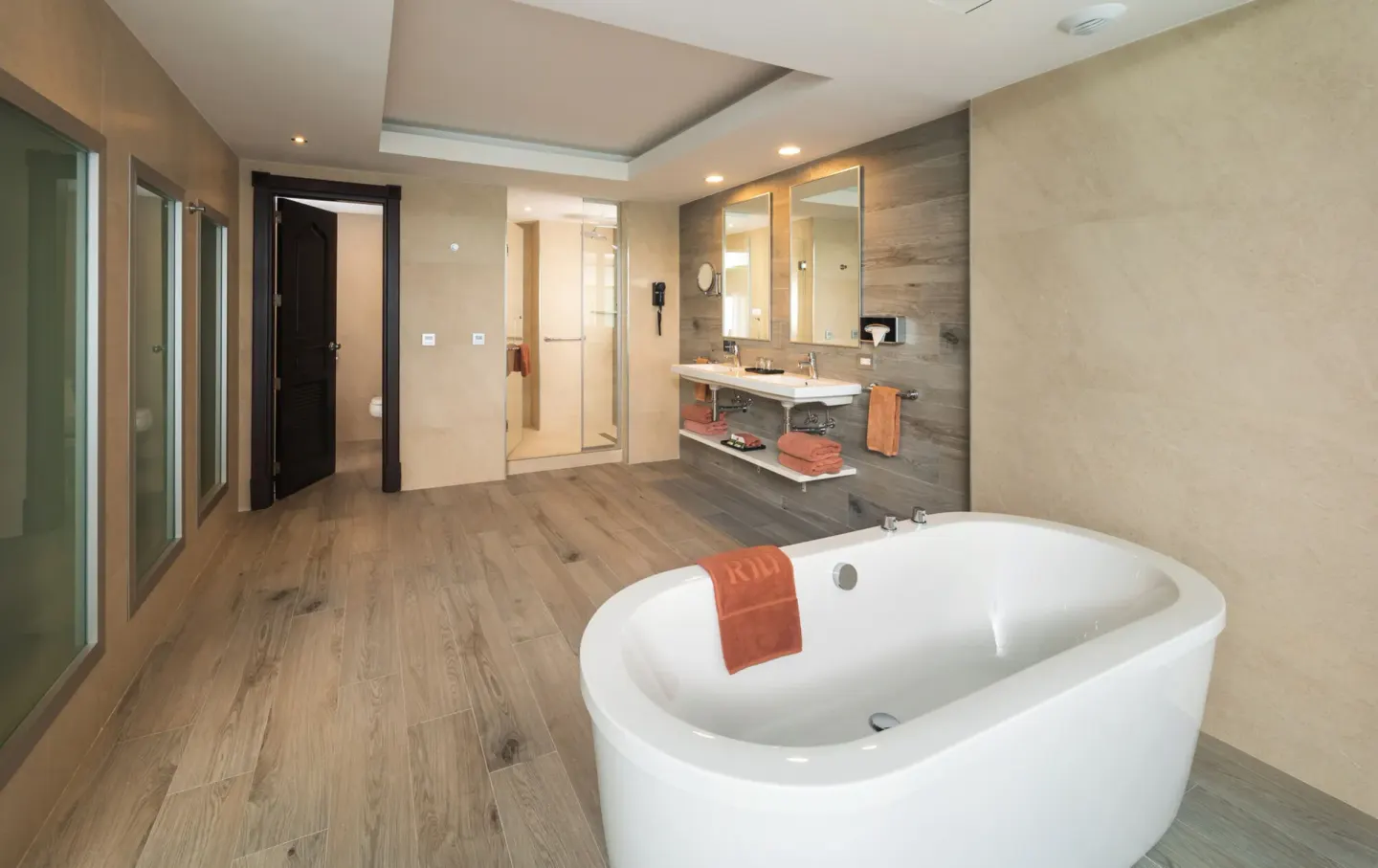 Ocean View Suite bathroom with freestanding tub, shower and double vanity at Hotel Riu Ocho Rios.