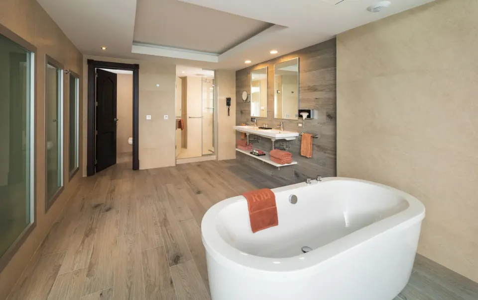 Ocean View Suite bathroom with freestanding tub, shower and double vanity at Hotel Riu Ocho Rios.