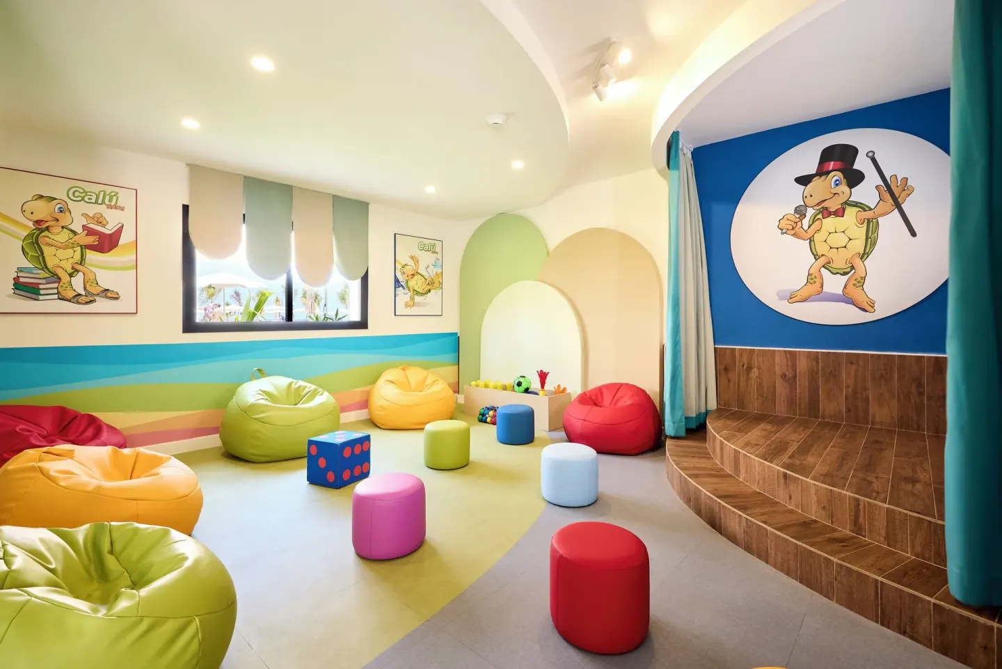 A colorful children's playroom with beanbags is shown at Hotel Riu Palace Aquarelle.