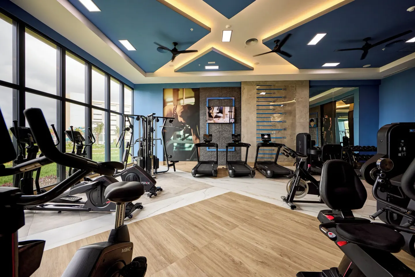 Fitness center with cardio and strength machines at Hotel Riu Palace Aquarelle.