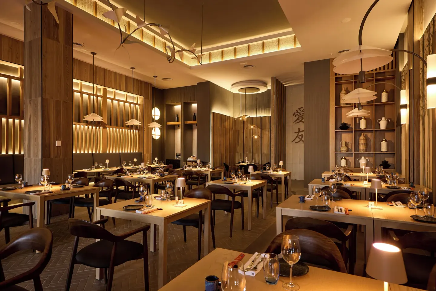 Asian restaurant dining room with wood décor at Hotel Riu Palace Aquarelle.