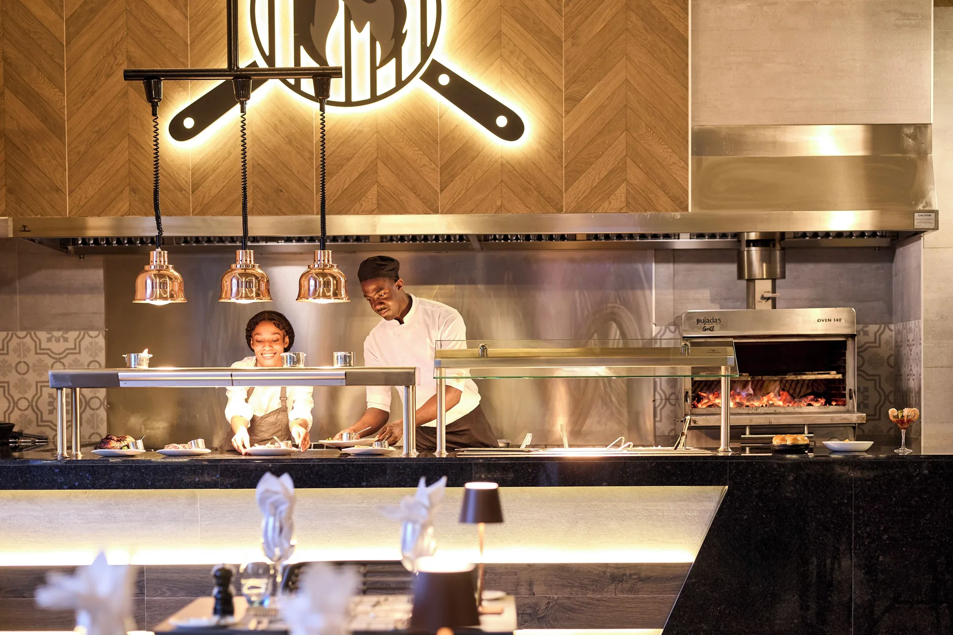 Open grill station with chefs at Hotel Riu Palace Aquarelle.