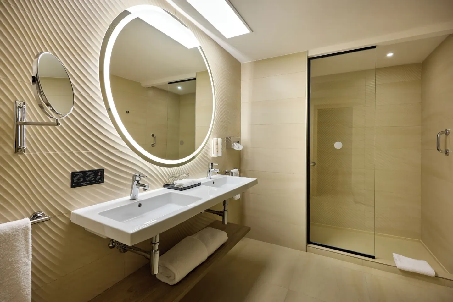Family Room bathroom with double sink and glass shower at Hotel Riu Palace Aquarelle.