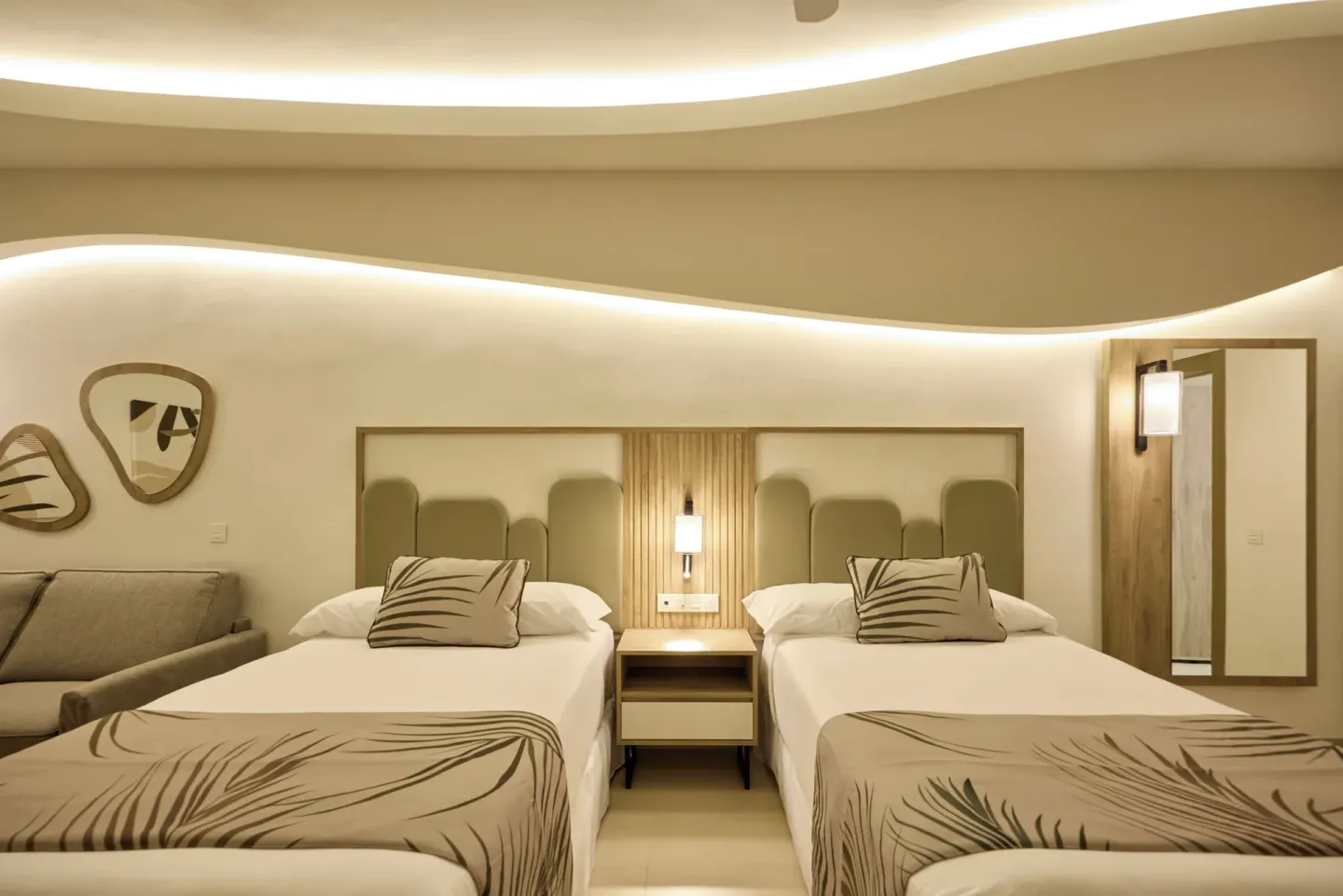 Family Room with two beds and a sofa at Hotel Riu Palace Aquarelle.
