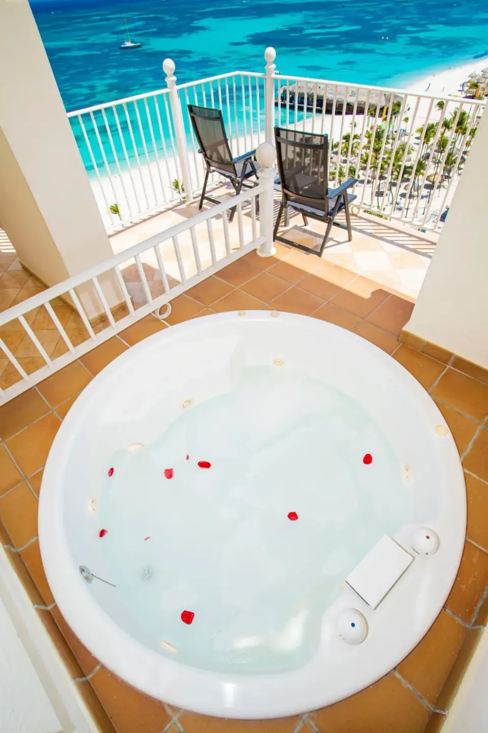 Balcony whirlpool, chairs, beach, and ocean at Hotel Riu Palace Aruba