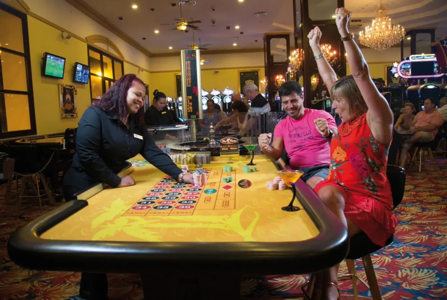 Casino table game with guests and staff at Hotel Riu Palace Aruba.