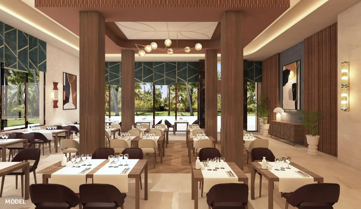 Bright restaurant dining room with garden-facing windows at Hotel Riu Palace Aruba.