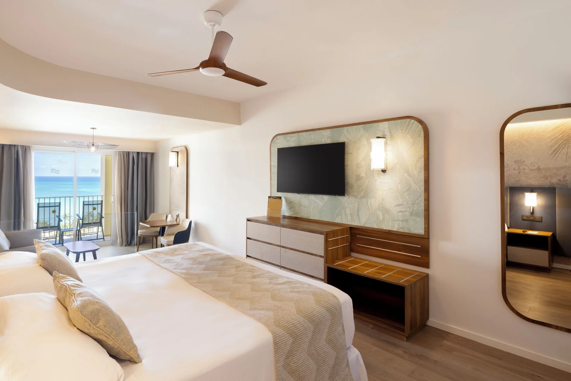 Junior Suite Ocean View with king bed and balcony at Hotel Riu Palace Aruba.