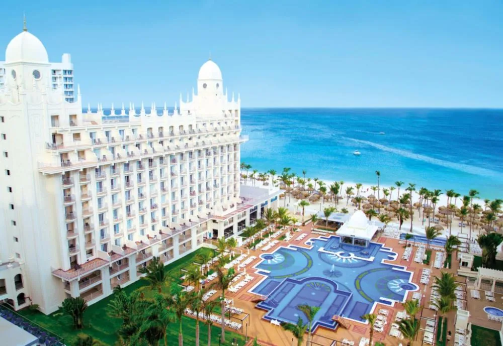 Partial sea view from a Junior Suite balcony at Hotel Riu Palace Aruba, overlooking pools and beach.