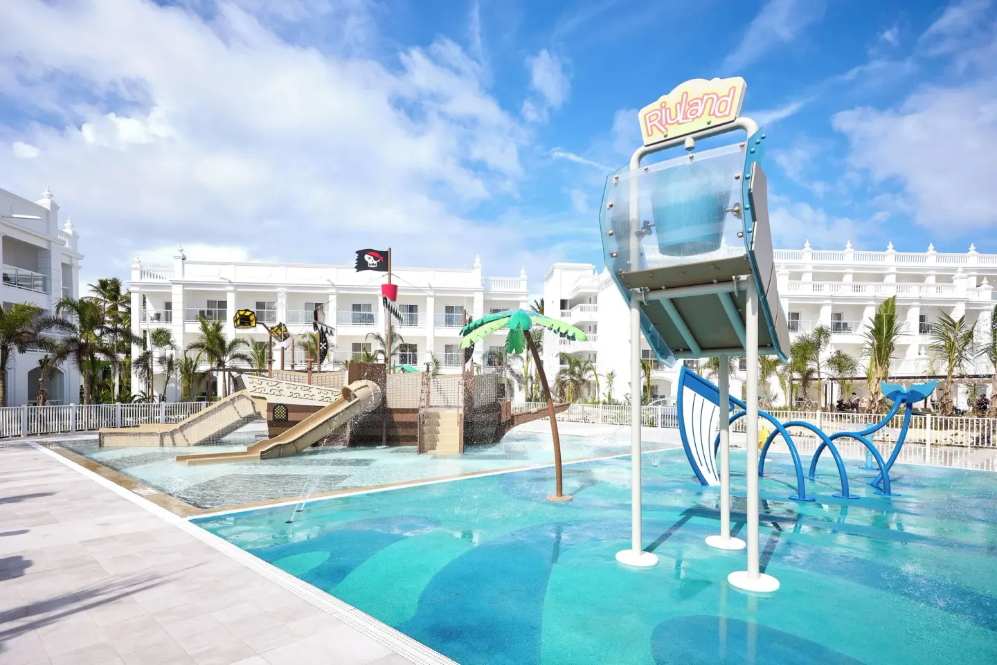 Children's splash pool with slides and tipping bucket at Hotel Riu Palace Bavaro.