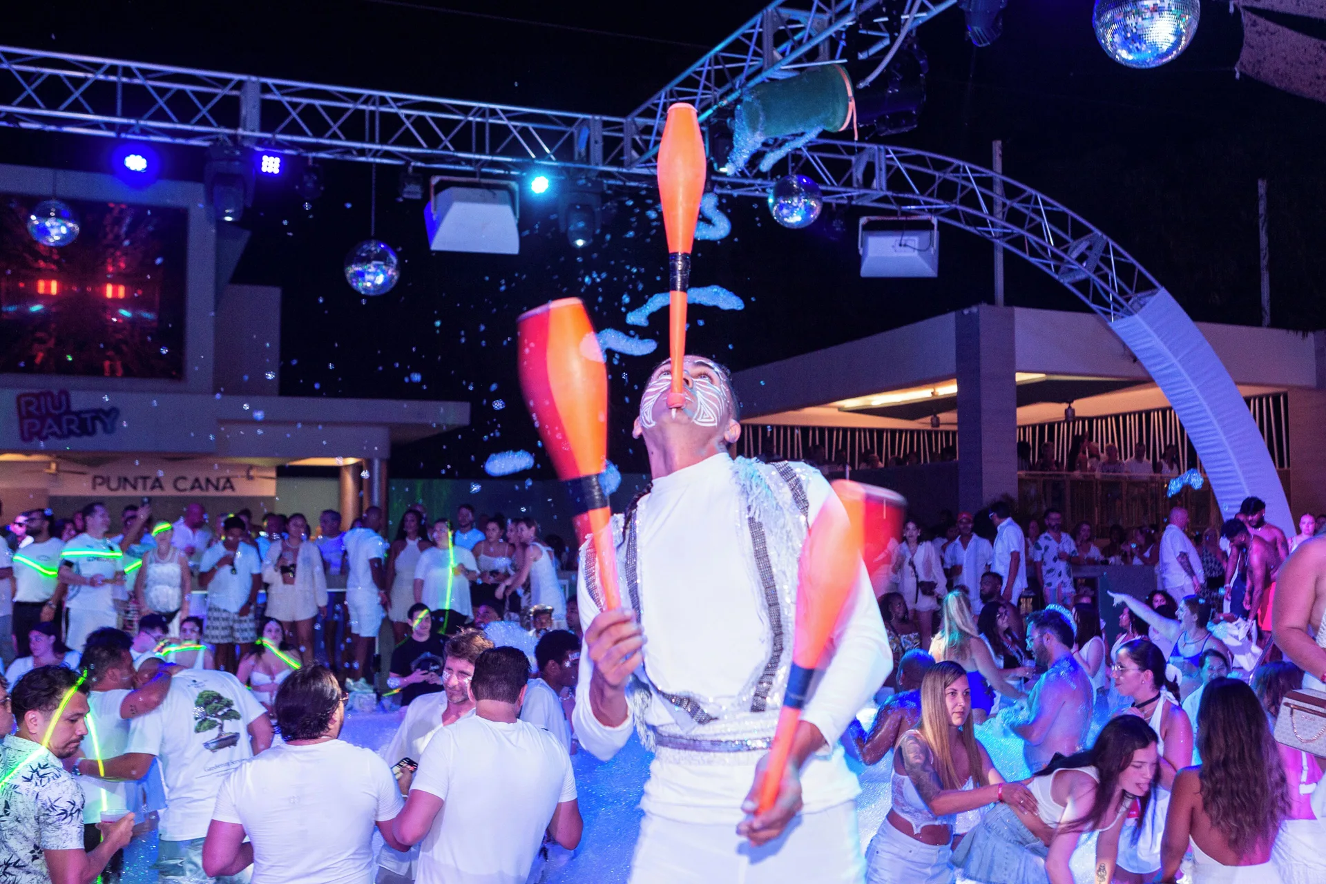 Juggler performing above a foam party crowd at Hotel Riu Palace Bavaro.
