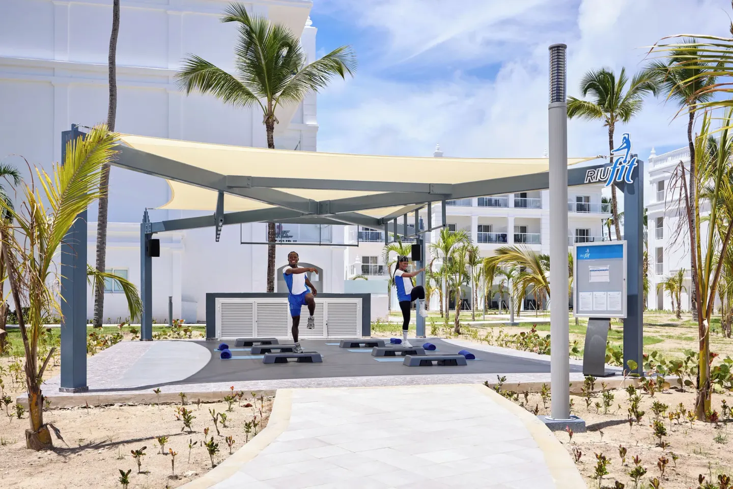 Outdoor fitness class area with shade canopy at Hotel Riu Palace Bavaro.