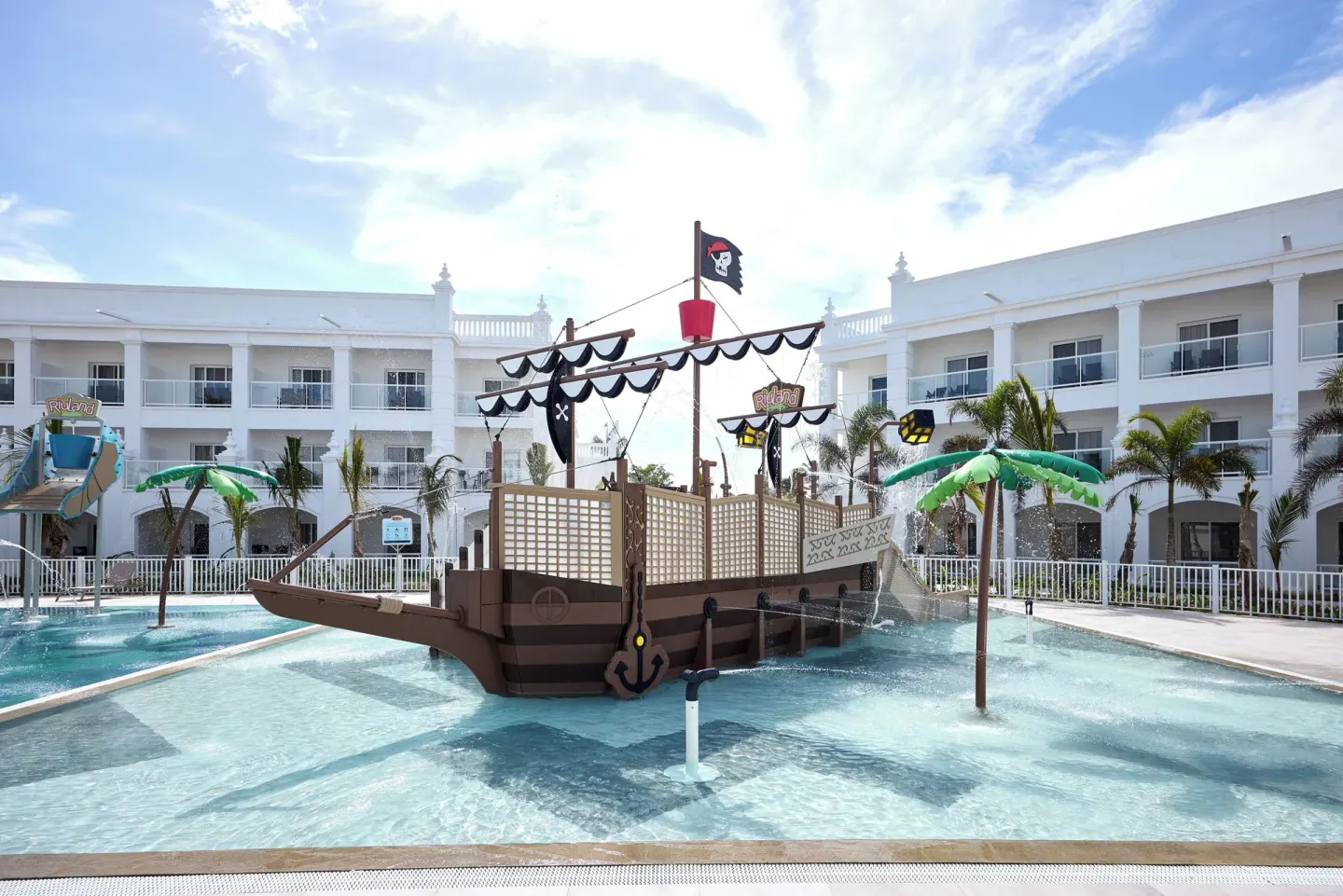 Pirate ship water play structure in a shallow pool at Hotel Riu Palace Bavaro.