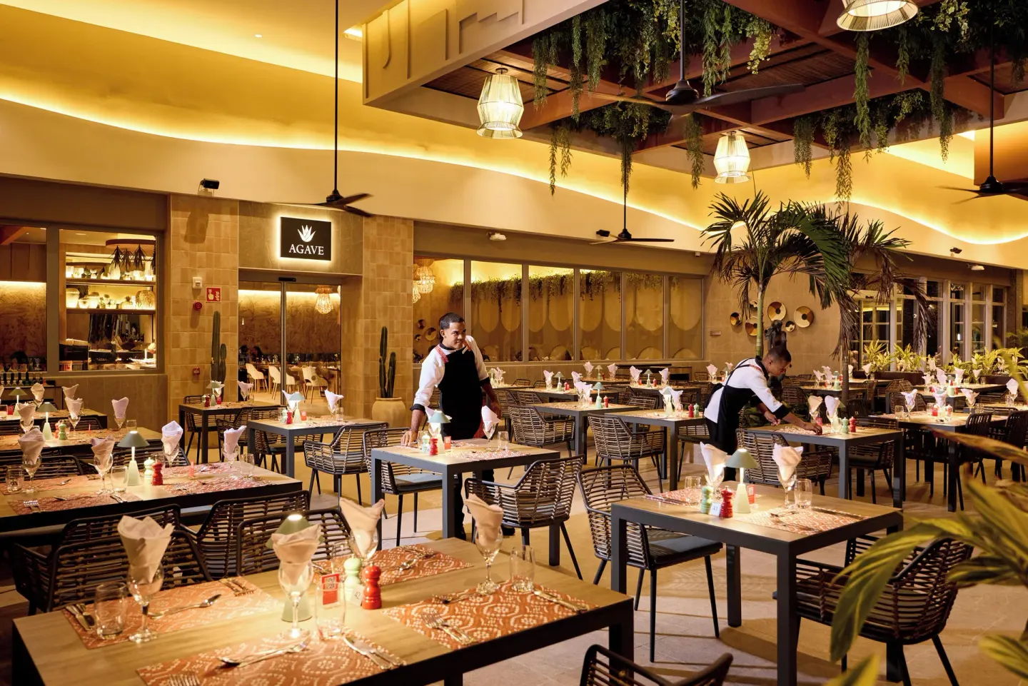 Agave restaurant dining room with set tables at Hotel Riu Palace Bavaro.
