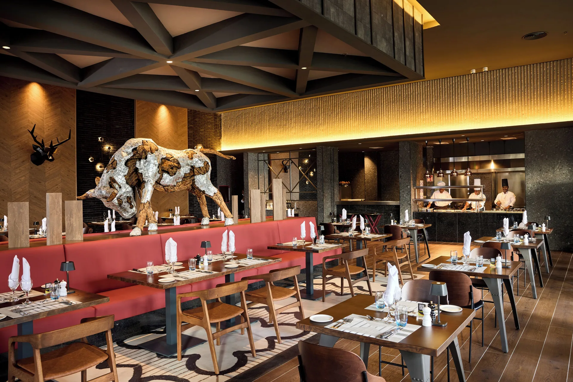 The Steakhouse dining room with bull sculpture at Hotel Riu Palace Bavaro.