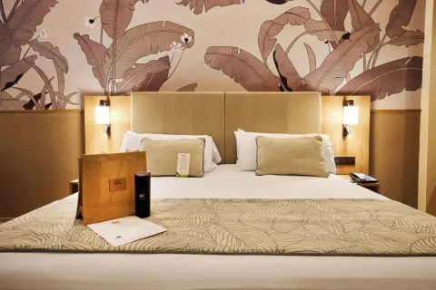 King bed in an Elite Club swim-up junior suite at Hotel Riu Palace Bavaro.