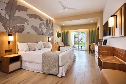 Elite Club swim-up junior suite with king bed and terrace at Hotel Riu Palace Bavaro.