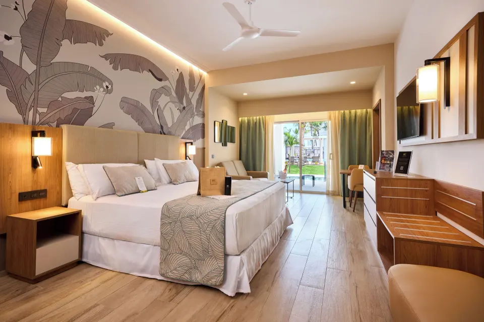 Elite Club swim-up junior suite with king bed and terrace at Hotel Riu Palace Bavaro.