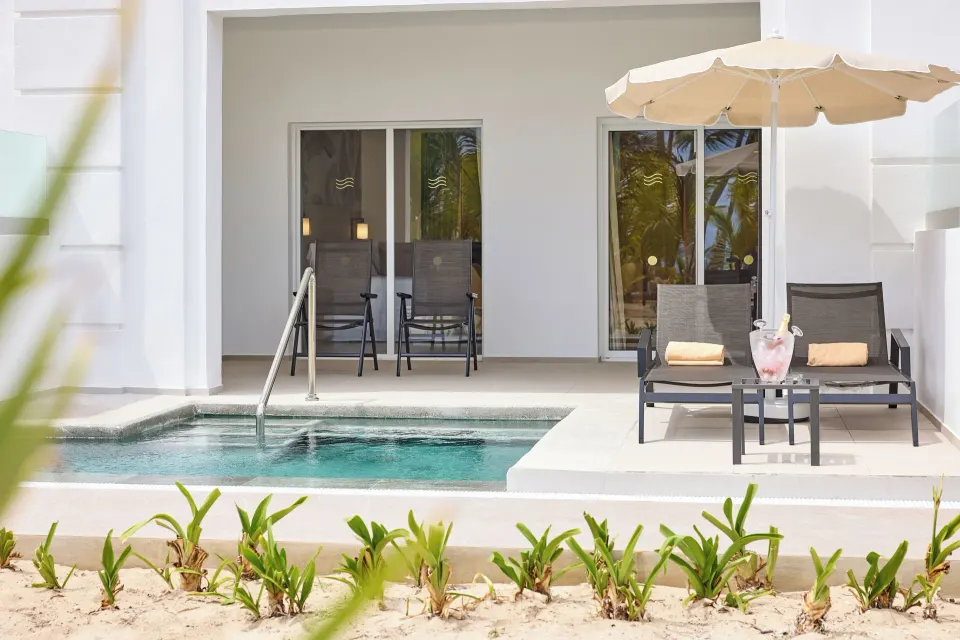 Elite Club Swim-up Suite patio with plunge pool and umbrella at Hotel Riu Palace Bavaro.