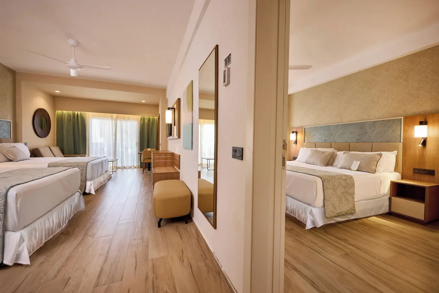 Two bedrooms in a Family Suite at Hotel Riu Palace Bavaro, seen from the connecting doorway.