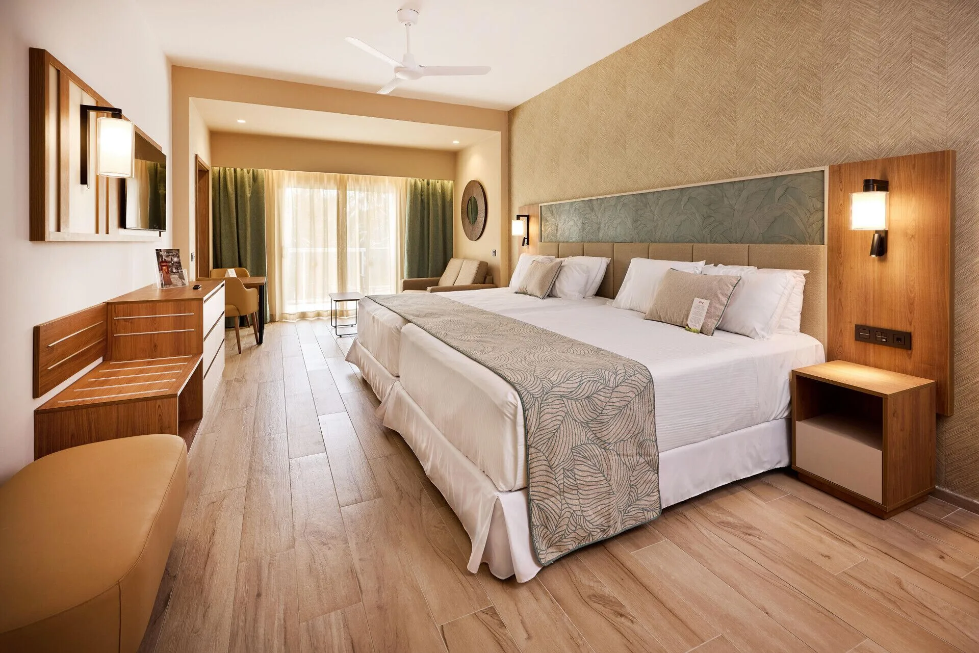 Junior Suite Garden View with two beds and sliding balcony doors at Hotel Riu Palace Bavaro.