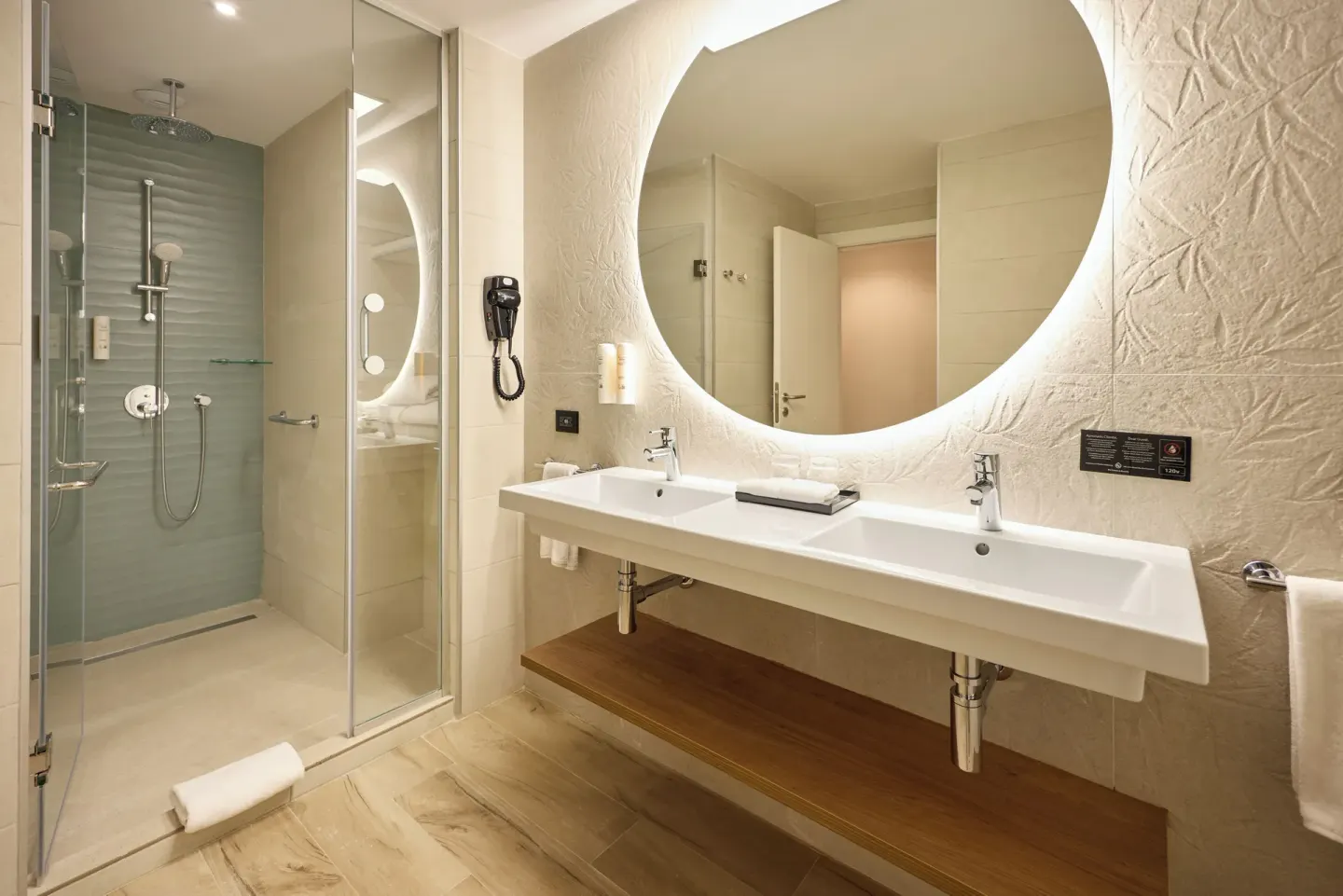 Junior Suite bathroom with double sinks and glass shower at Hotel Riu Palace Bavaro.
