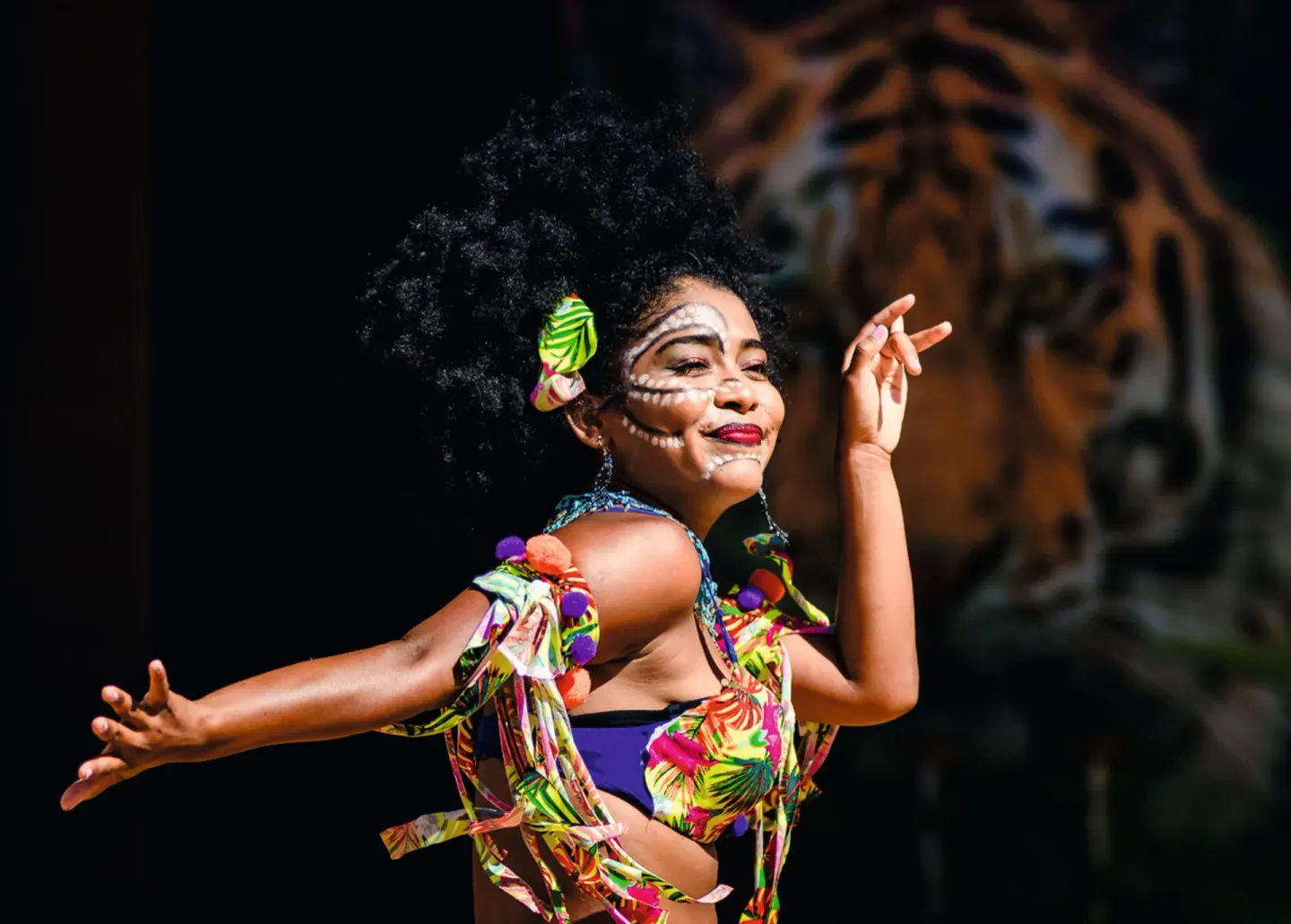 Costumed dancer with face paint performing at Hotel Riu Palace Cabo San Lucas.