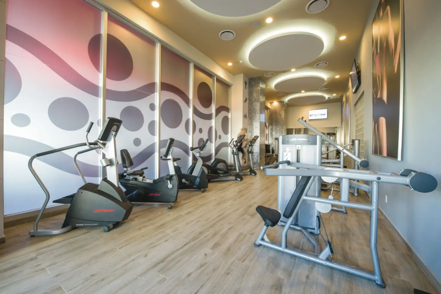 Fitness center with cardio and strength equipment at Hotel Riu Palace Cabo San Lucas.