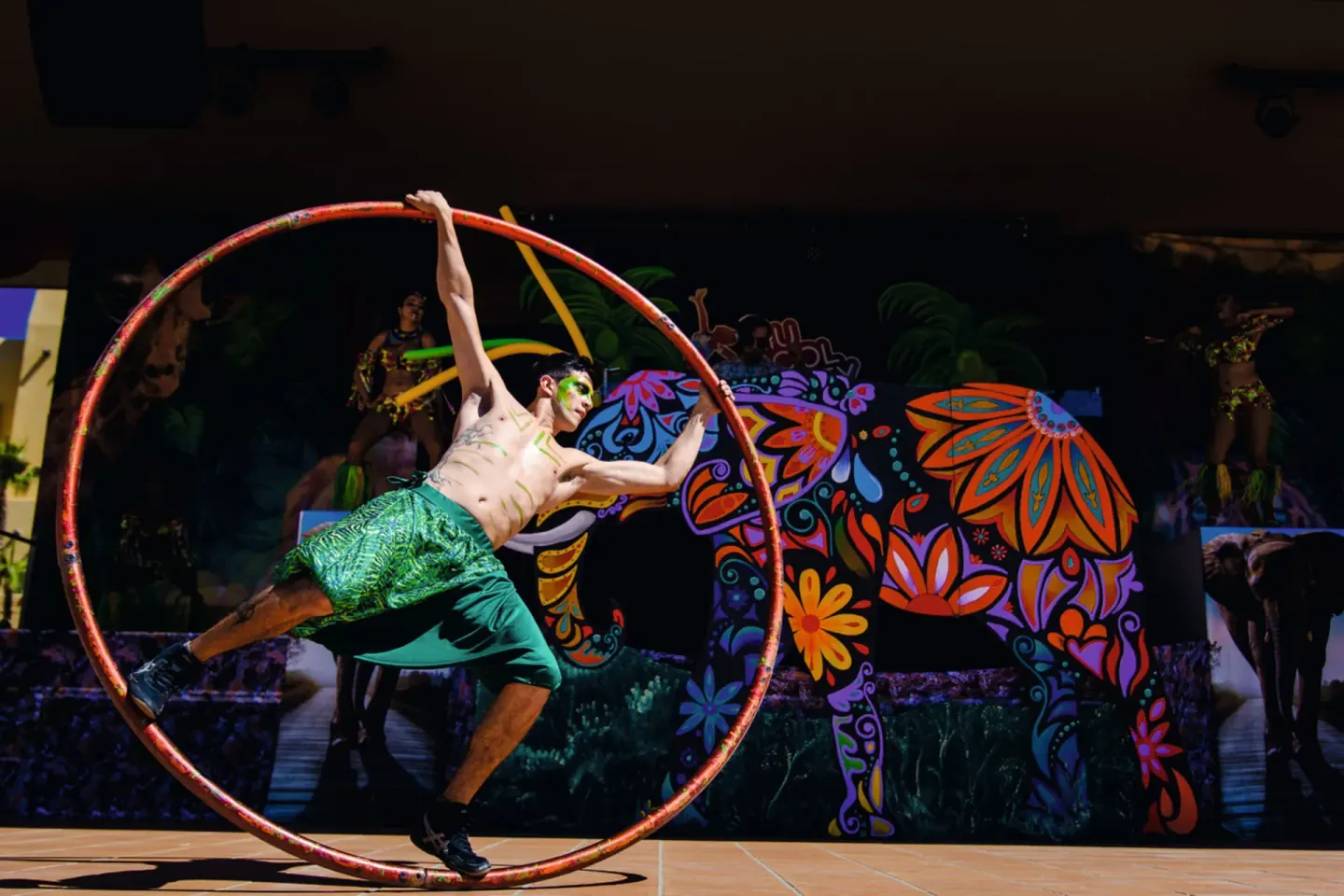 Cyr wheel performer on an outdoor stage at Hotel Riu Palace Cabo San Lucas.
