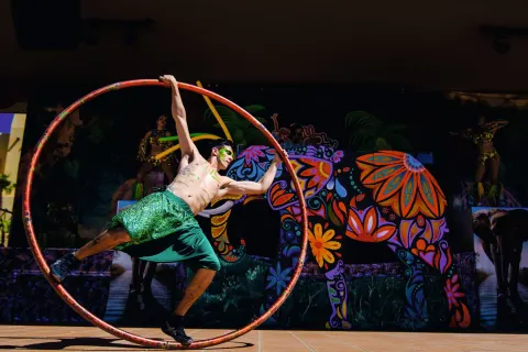 Cyr wheel performer on an outdoor stage at Hotel Riu Palace Cabo San Lucas.