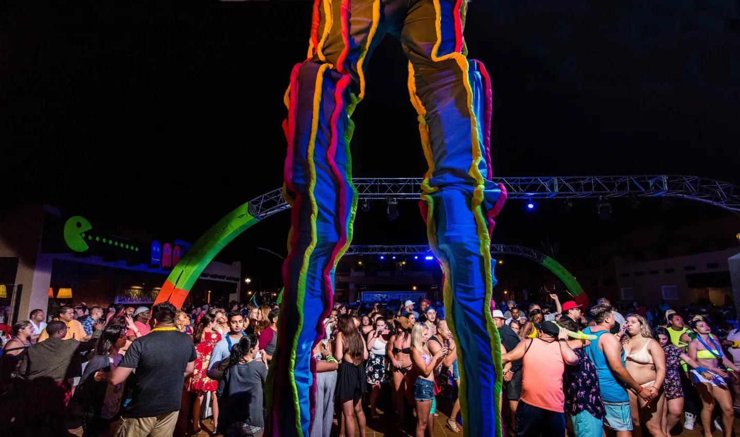 Stilt performer above a crowded night party at Hotel Riu Palace Cabo San Lucas.