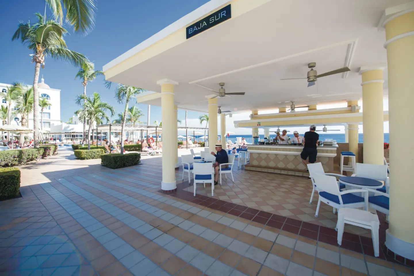 Baja Sur bar with shaded seating by the pool at Hotel Riu Palace Cabo San Lucas.