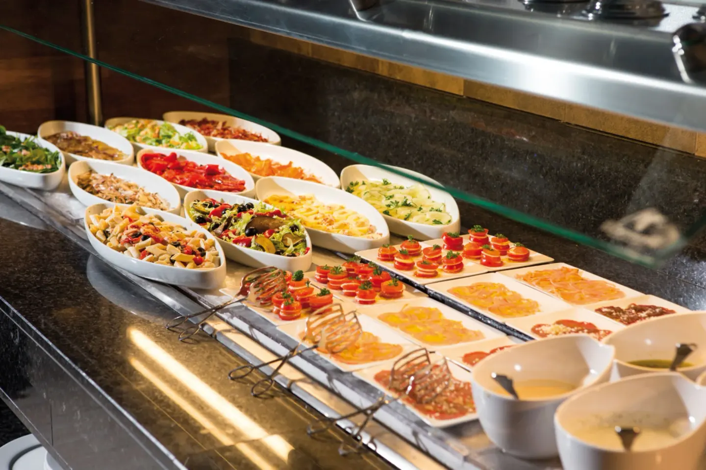 Buffet counter with salads and cold appetizers at Hotel Riu Palace Cabo San Lucas.