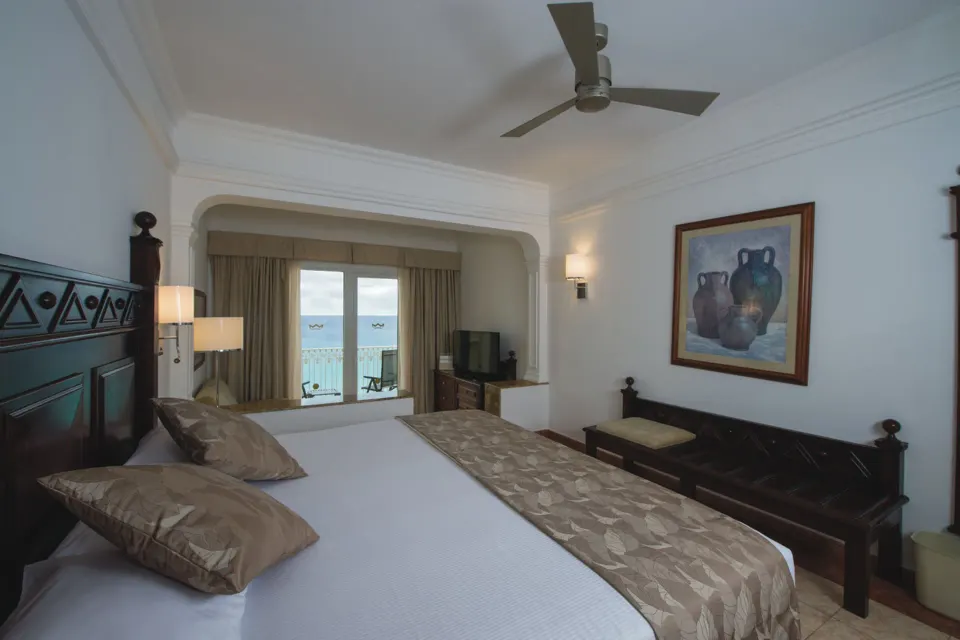 Junior Suite Ocean View with king bed and balcony at Hotel Riu Palace Cabo San Lucas.