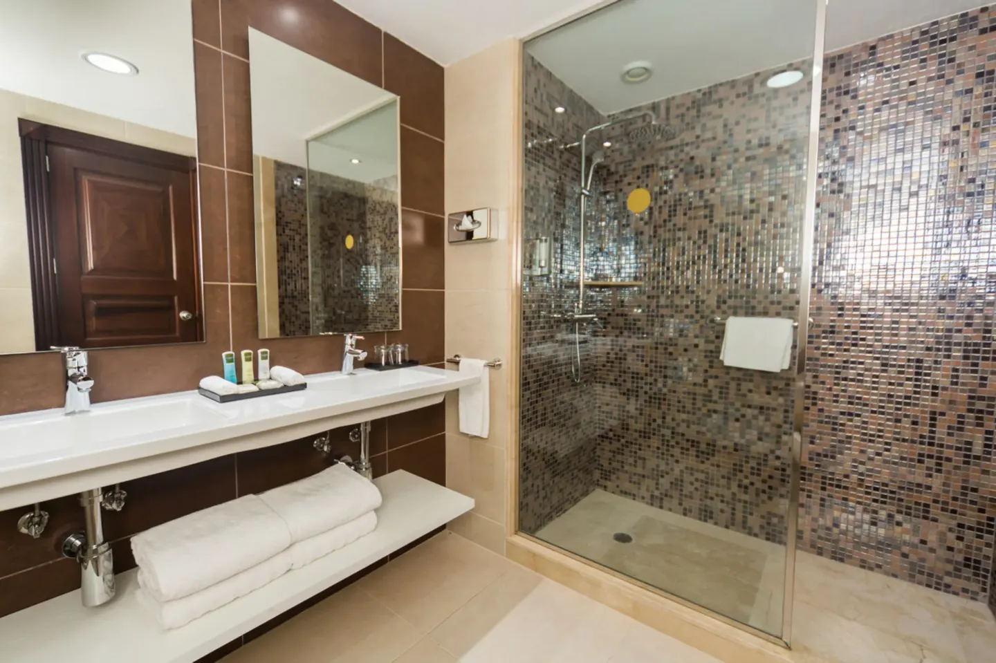 Junior Suite Swim Up bathroom with double vanity and glass shower at Hotel Riu Palace Cabo San Lucas.