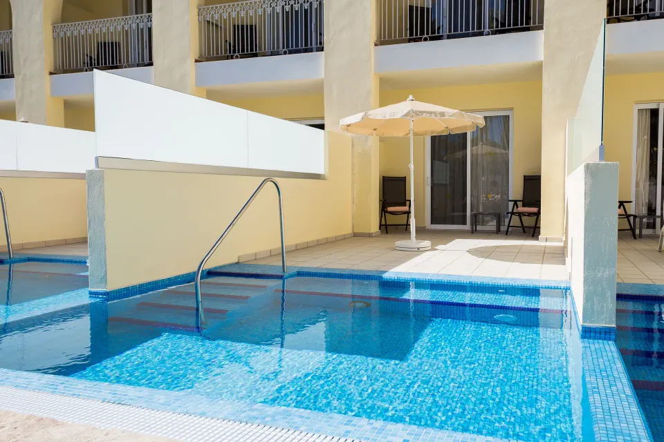 Junior Suite Swim Up patio and pool steps at Hotel Riu Palace Cabo San Lucas.