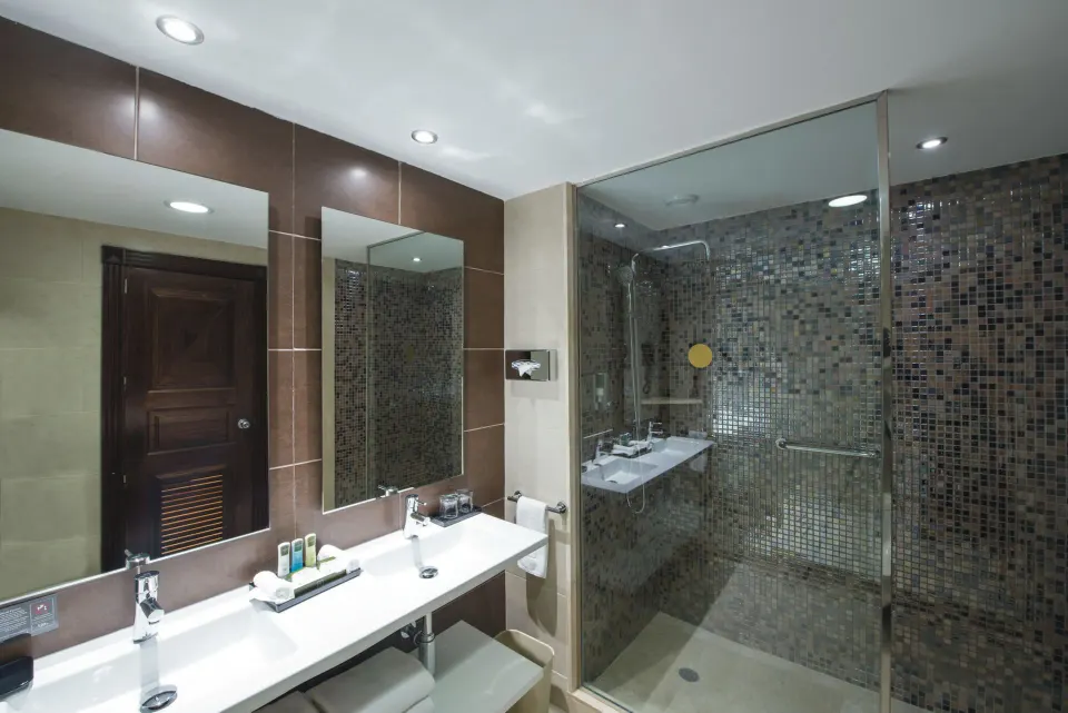 Junior Suite bathroom vanity and glass shower at Hotel Riu Palace Cabo San Lucas.